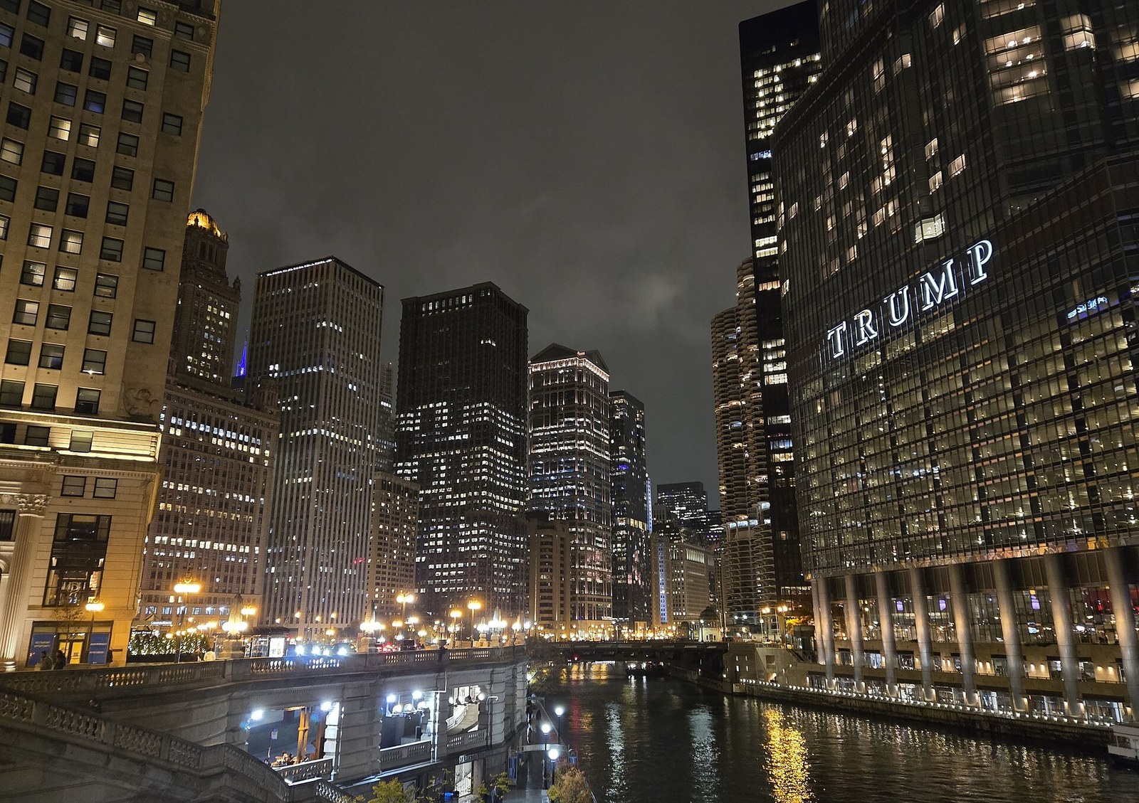 Chicago towers reflected in the river after dark.